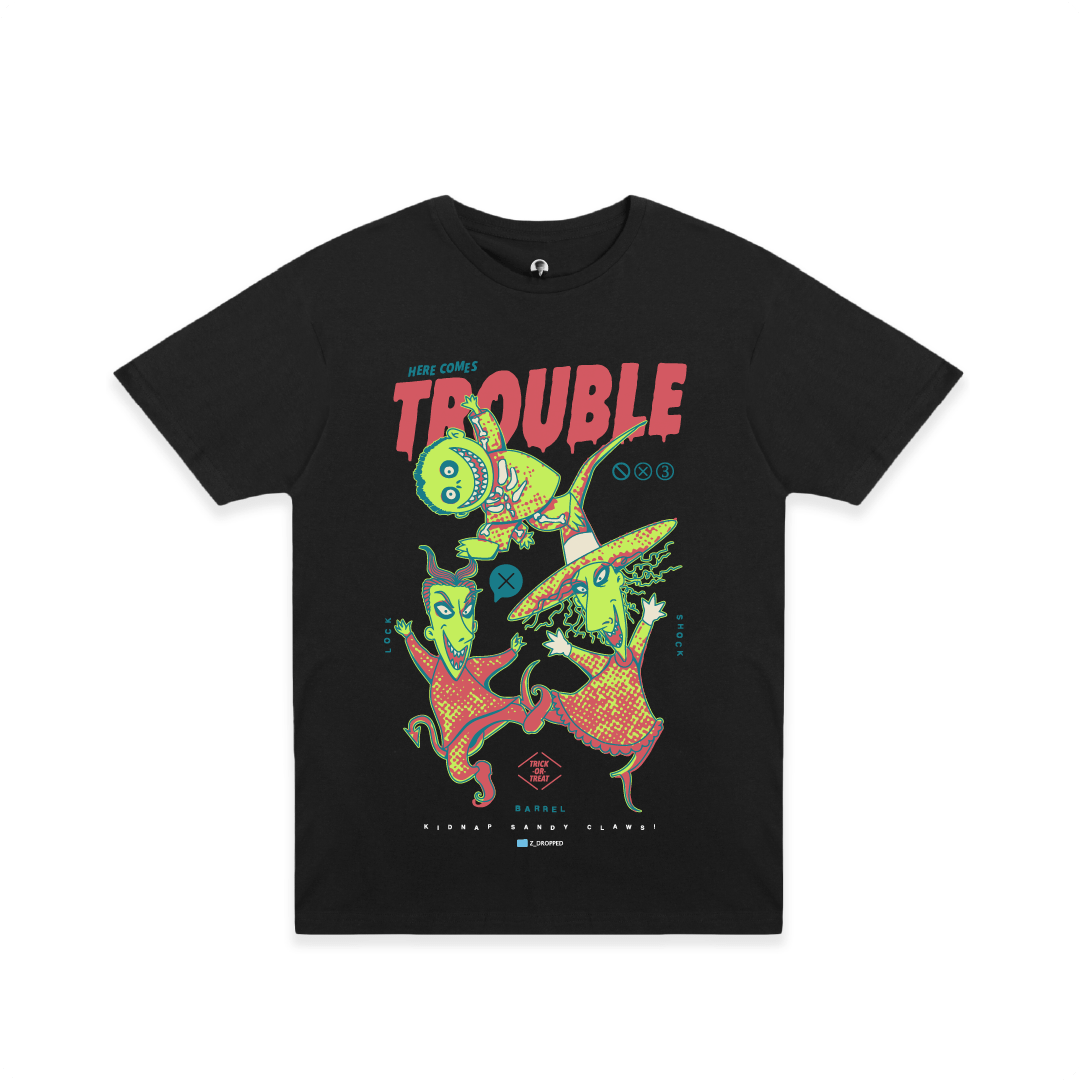 Front view of a black t-shirt with colorful lock shock and barrel and 'Here Comes Trouble' text on a white background