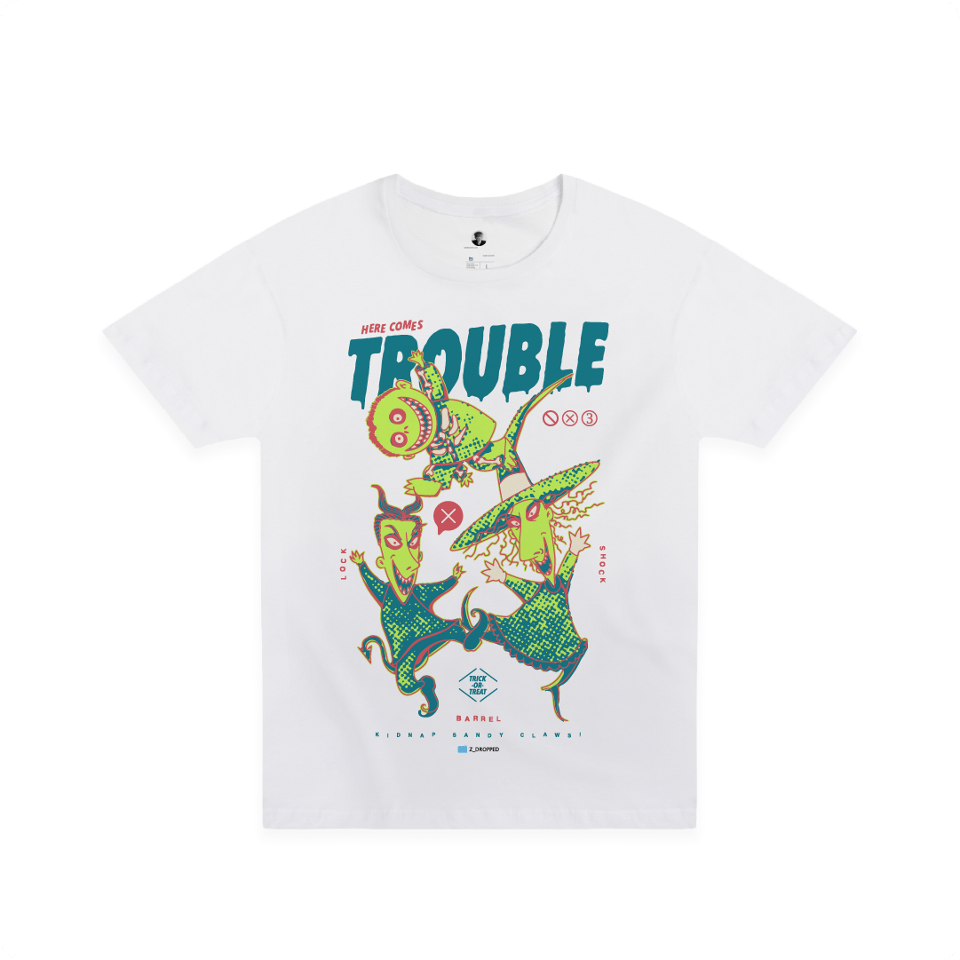 Front view of a white t-shirt with colorful lock shock and barrel and 'Here Comes Trouble' text on a white background