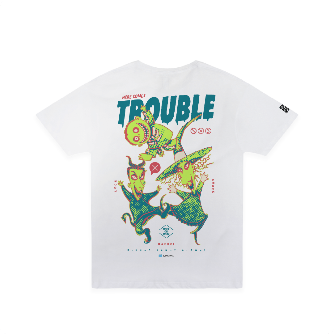 Rear view of a white t-shirt with colorful lock shock and barrel and 'Here Comes Trouble' text on a white background