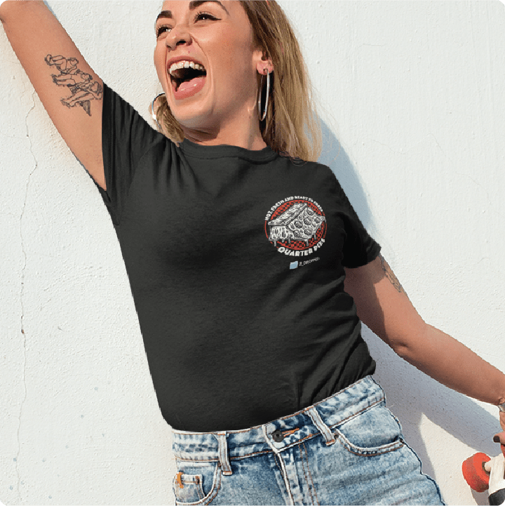 Skater girl wearing a black zdropped quarter pipe pizza high waisted t-shirt waving at a friend against a white wall. 