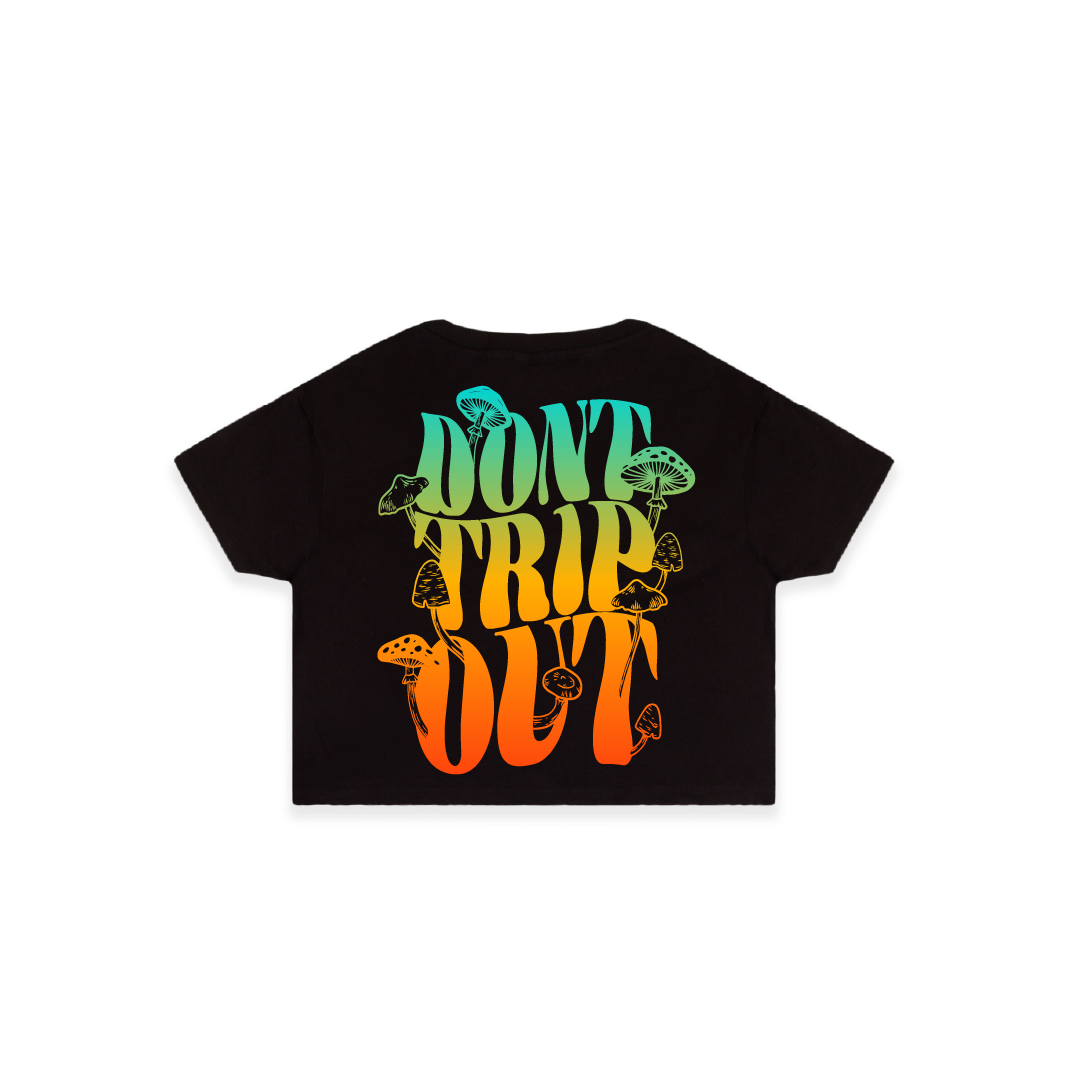Rear view of a women's black crop top t-shirt with a large 'DON'T TRIP OUT' text and mushrooms printed in colorful letters.