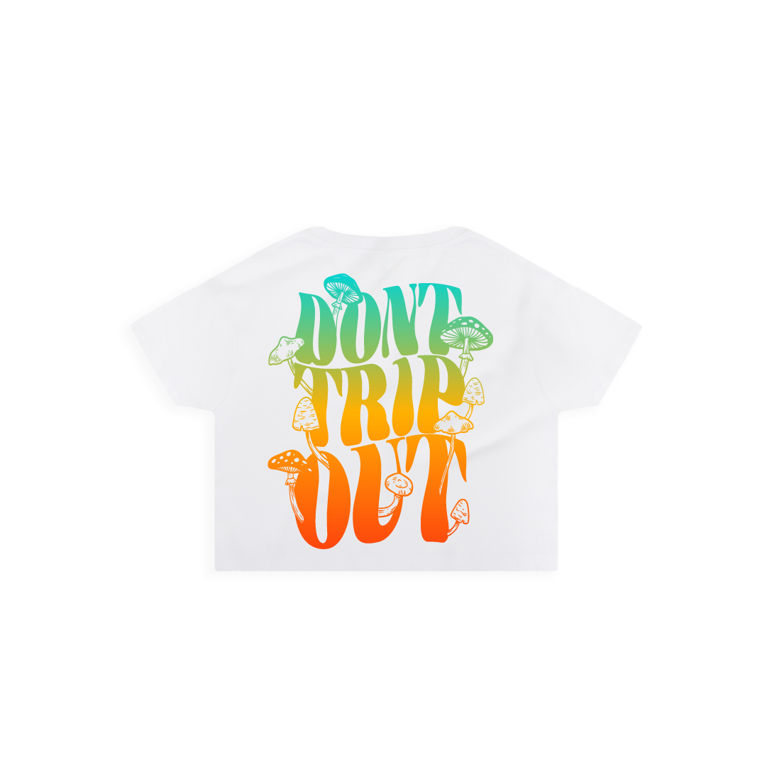 Rear view of a women's white crop top t-shirt with a large 'DON'T TRIP OUT' text and mushrooms printed in colorful letters.