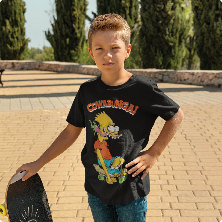 Young man wearing a Bart Roth zdropped t-shirt while holding a skateboard outdoors. 