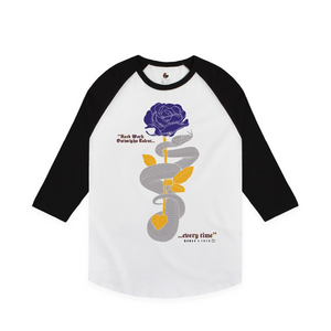 Front view of a unisex white and black baseball shirt with a purple and gold rose and grey mamba snake on a white background with text that reads "Hard work outweighs talent...every time"
