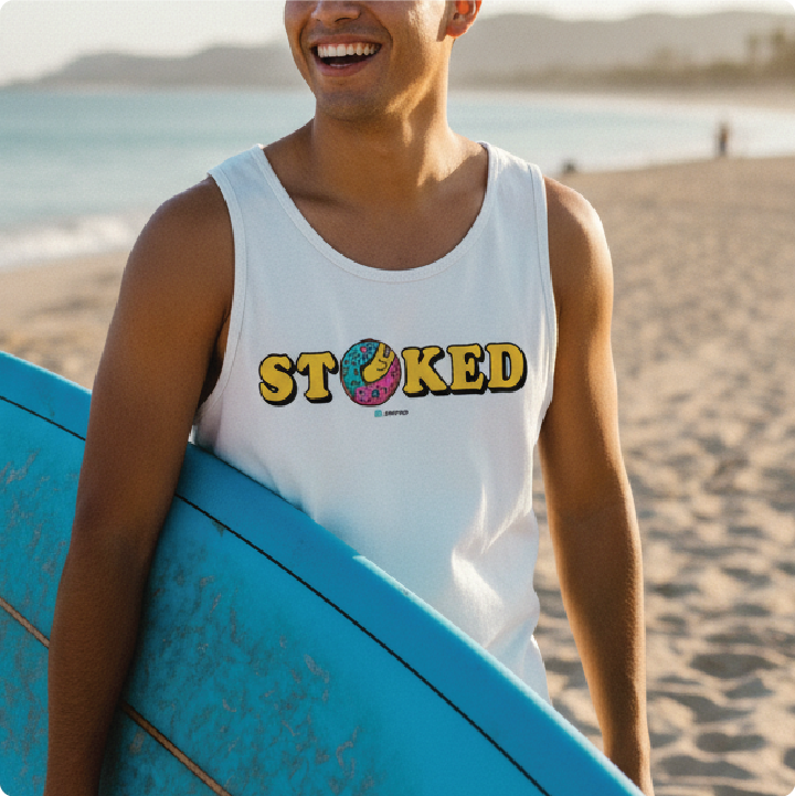 Surfer holding a surfboard in a white 'STOKED' tank top at the beach.