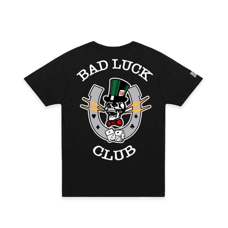 Rear view of a unisex black crew neck t-shirt with white 'BAD LUCK CLUB' text and a large graphic including a laughing skull, dice, and lightning bolts on a white background.