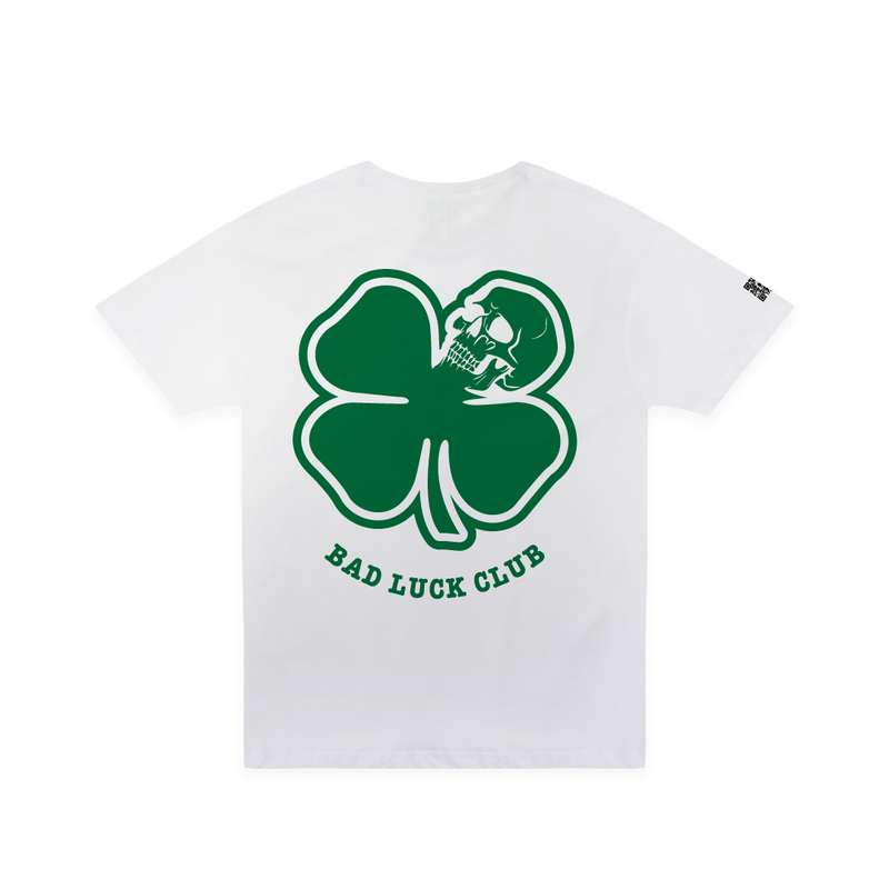 Rear view of a white crew neck t-shirt with a green clover graphic that says Bad Luck Club on the back.