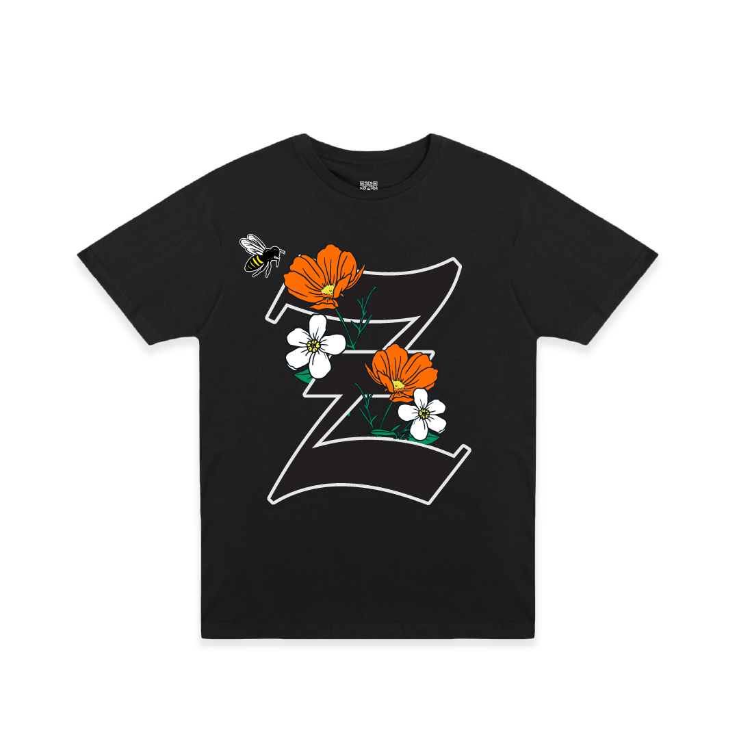 Front view of a black t-shirt with large California poppy and 'Z' design on a white background
