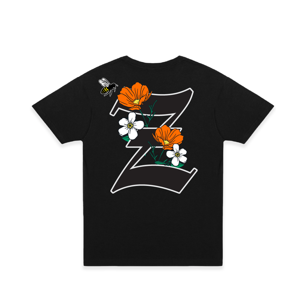 Rear view of a black t-shirt with large California poppy and 'Z' design on a white background