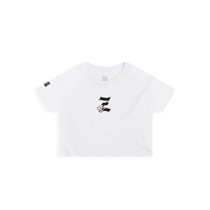 Front view of a women's white crop top t-shirt with a small black 'Z' logo and pink cherry blossom flower on a white background