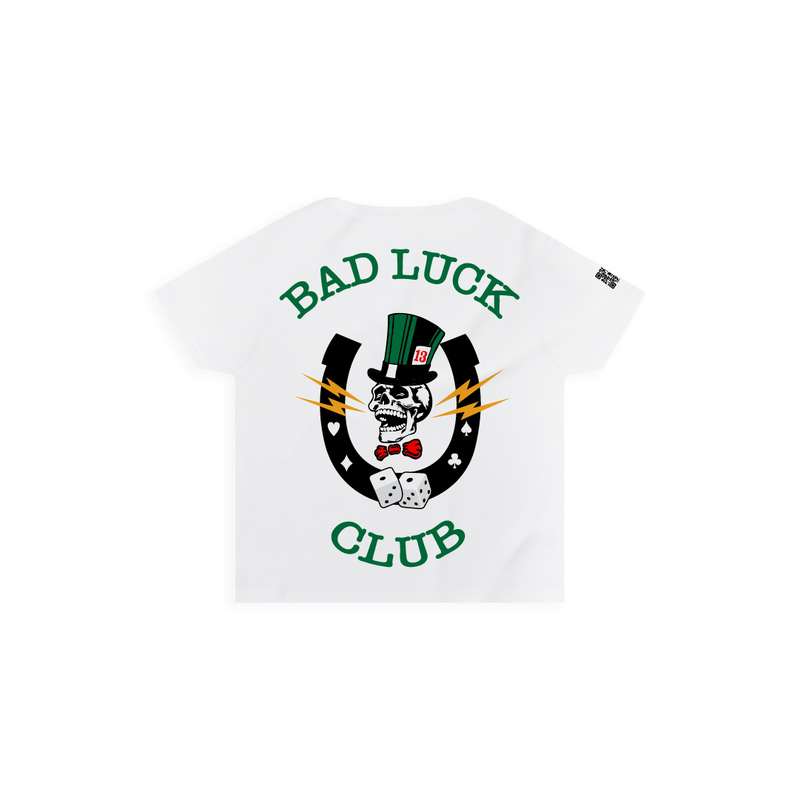 Rear view of a womens high-waisted t-shirt with a large graphic featuring a skull with bolts around it, and text that reads 'Bad Luck Club' on a white background.