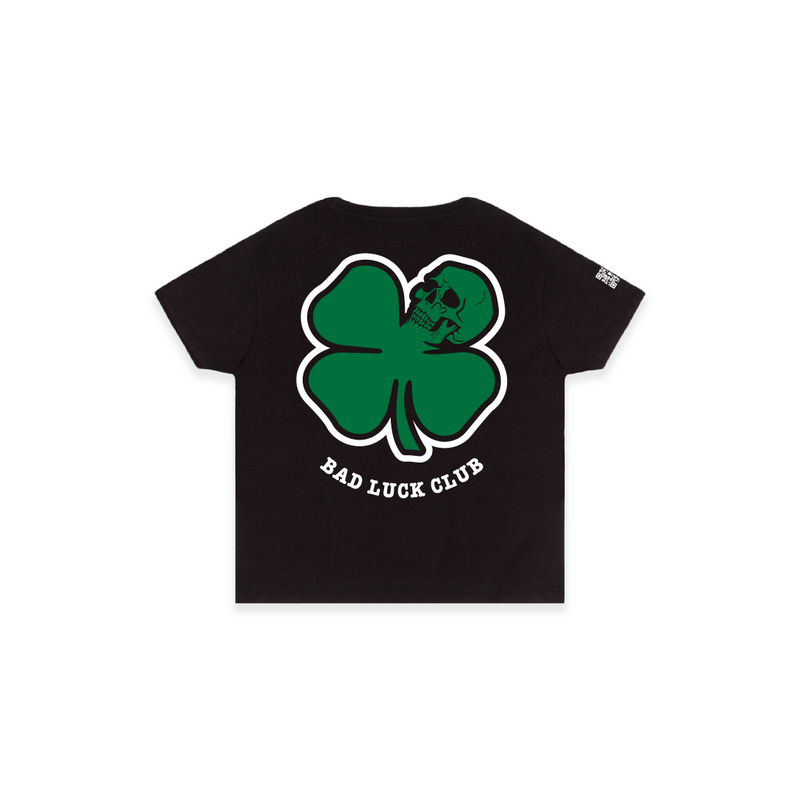 Rear view of a black high waisted t-shirt with a large green skull death clover graphic and 'Bad Luck Club' text.