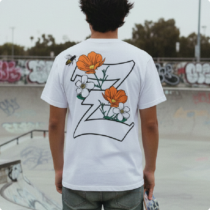 Person wearing a white t-shirt with a floral design and letter 'Z' at a skate park.