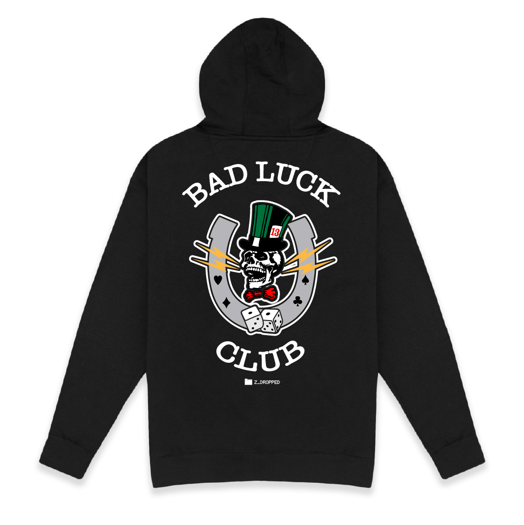 Rear view of a unisex black hoodie with 'Bad Luck Club' design featuring a high roller skull head with a green top hat with the number 13 and red bowtie  inside a grey horseshoe with rolling dice centered on the back.