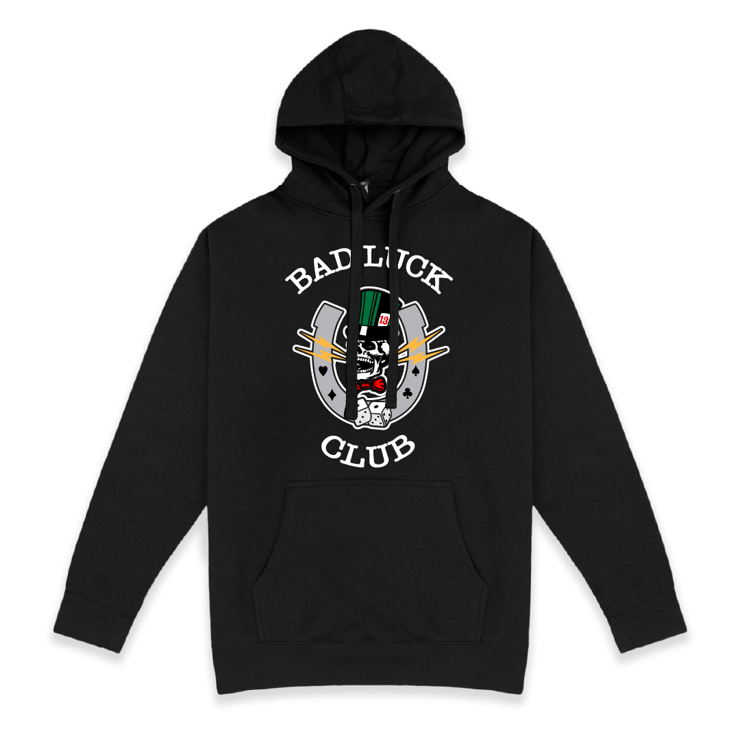 Front view of a unisex black hoodie with 'Bad Luck Club' design featuring a high roller skull head with a green top hat with the number 13 and red bowtie  inside a grey horseshoe with rolling dice centered on the back.