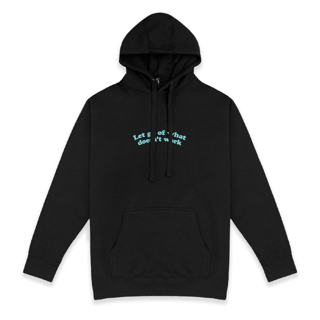 Front view of a black hoodie with Let Go Of What Doesn't Work text on a white background