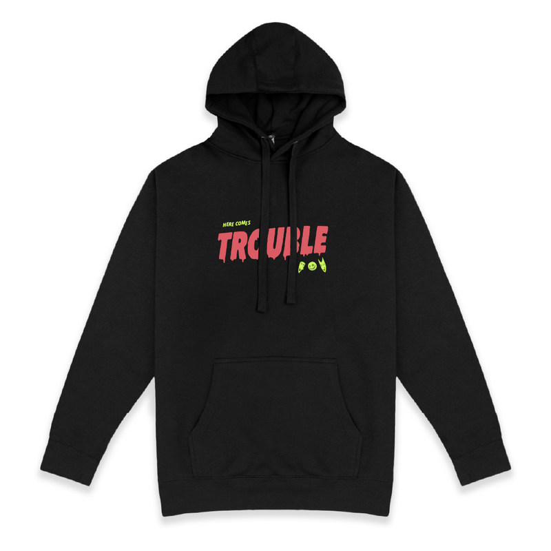Front view of a unisex black hoodie with colorful 'Here Comes Trouble' text on a white background