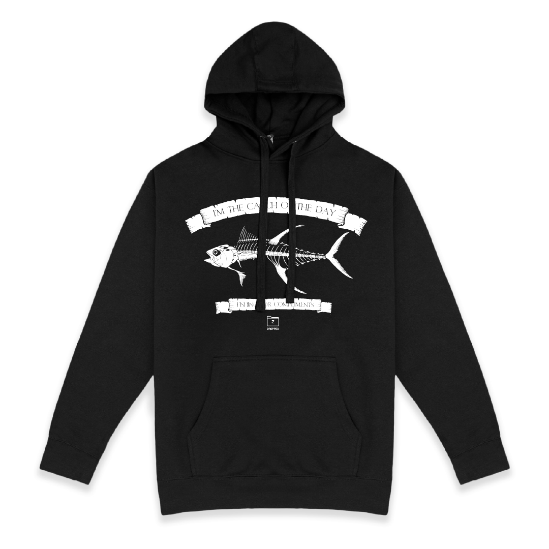 Front view of a unisex black hoodie with large white tuna bones graphic on a white background with white text that reads "I'm the catch of the day" on the top of the fish graphic and "fishing for compliments" in white text below the graphic