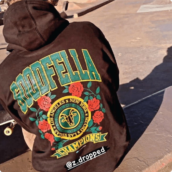 rear view of dreadlywraps wearing a black goodfella hoodie at a skate park