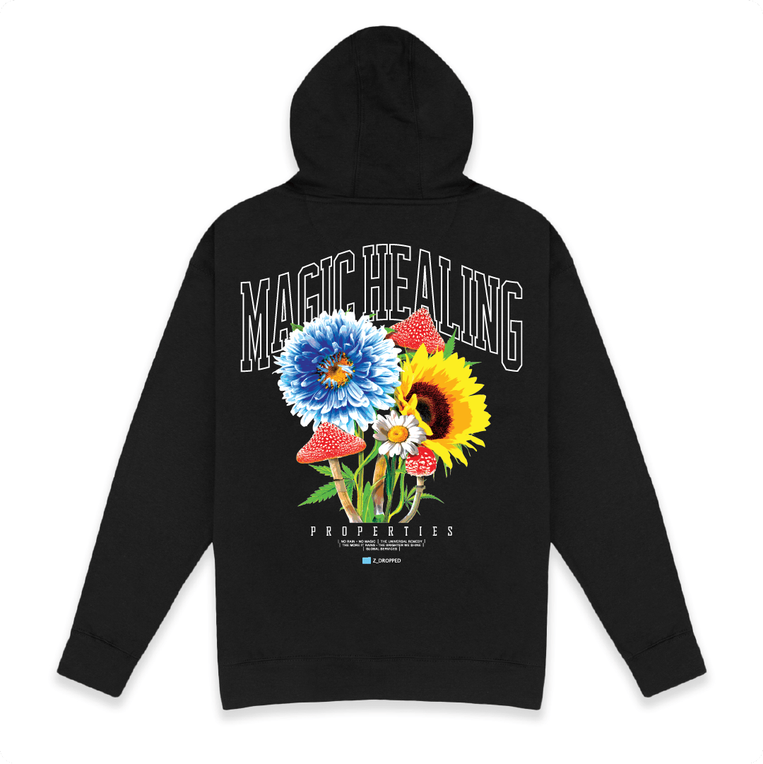 Rear view of a unisex black hoodie with floral design and Magic Healing text on a white background