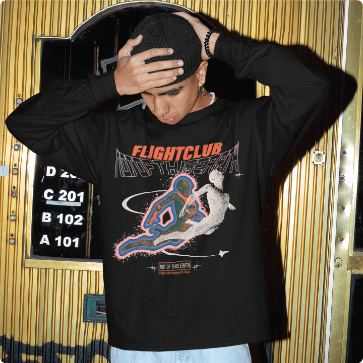 Person wearing a black 'Flight Club' long sleeve tee with a 'Flgith Club' graphic on the front.