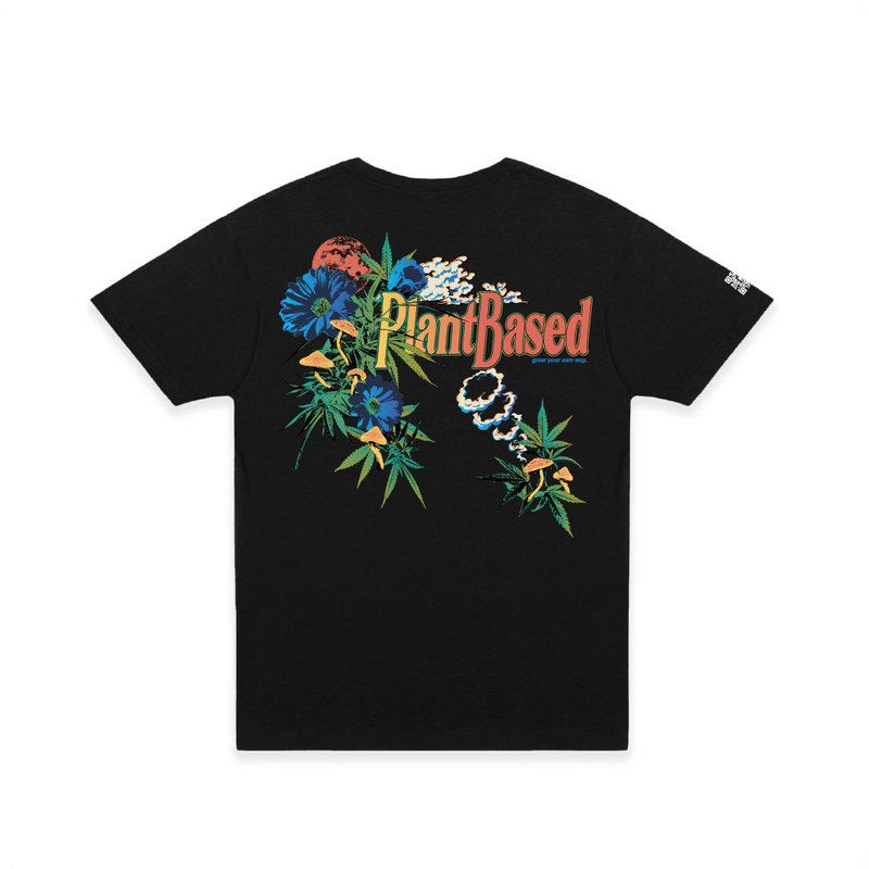 Rear view of a unisex black t-shirt with floral weed leaf design and colorful 'Plant Based' text with mushrooms on a white background.