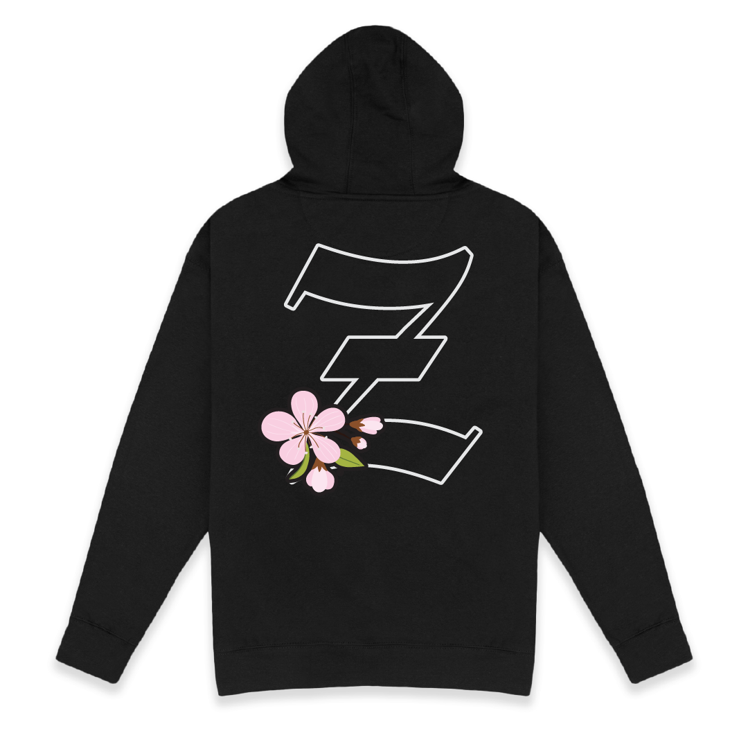 Rear view of a black hoodie with a large Z logo with a cherry blossom on the chest against a white background