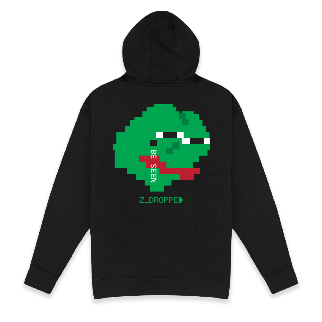 Rear view of a unisex black pullover hoodie with a large pixelated green sad face frog  graphic featuring the words BE SEEN and ZEPÉ logo, styled in retro 8-bit design, on a white background.