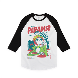 Raglan shirt with a cartoon skeleton character and 'Paradise' text on a white background
