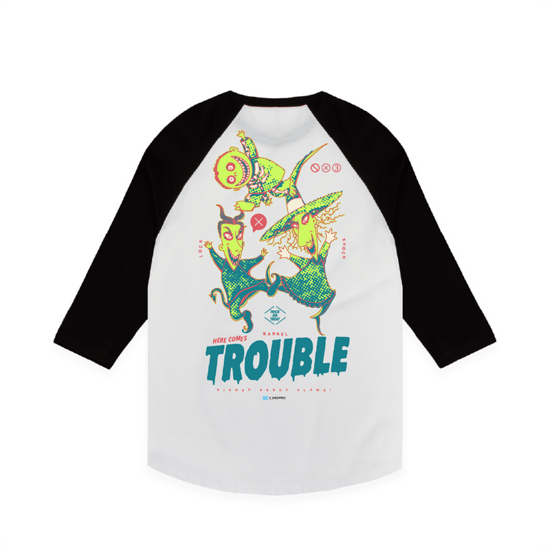 Rear view of a white and black baseball tee with colorful lock shock and barrel and 'Here Comes Trouble' text on a white background