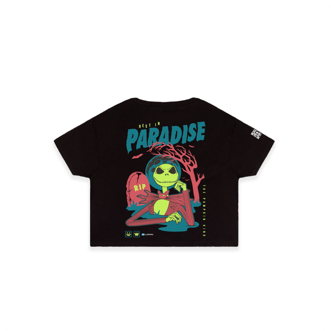 Rear view of a womens black crop top shirt with a colorful skeleton graphic featuring a 'Rest in Paradise' text on a white background.