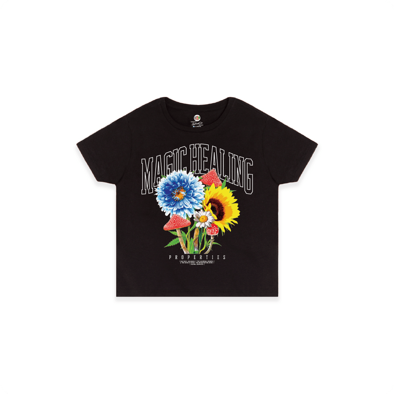 Front view of a women's black high waisted shirt with flowers psychedelic mushrooms and large white 'MAGIC HEALING' text.