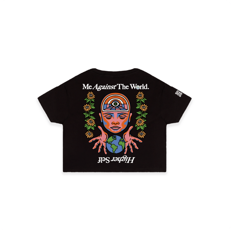 rear view of a black crop top t-shirt with colorful Me against the world graphic and text on a white background