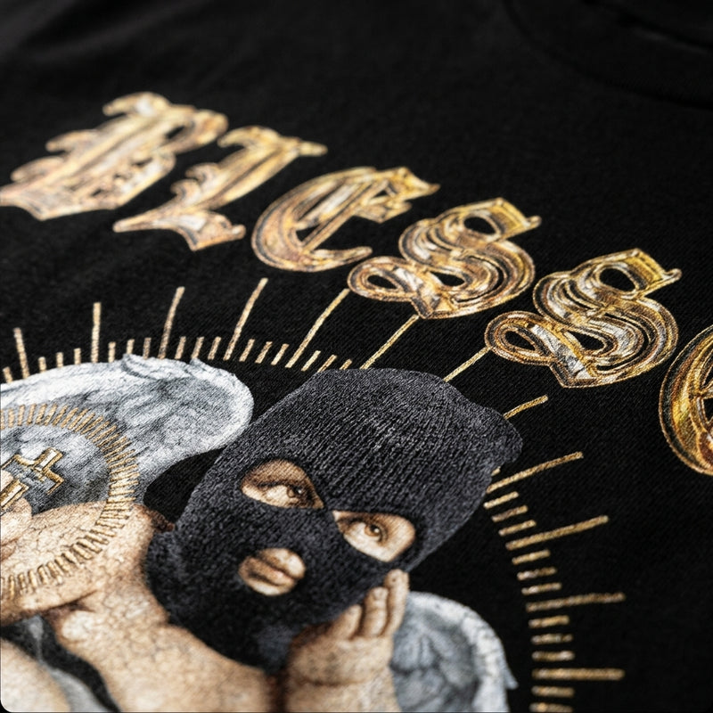 close up shot of zdropped blessed tee on a black garment