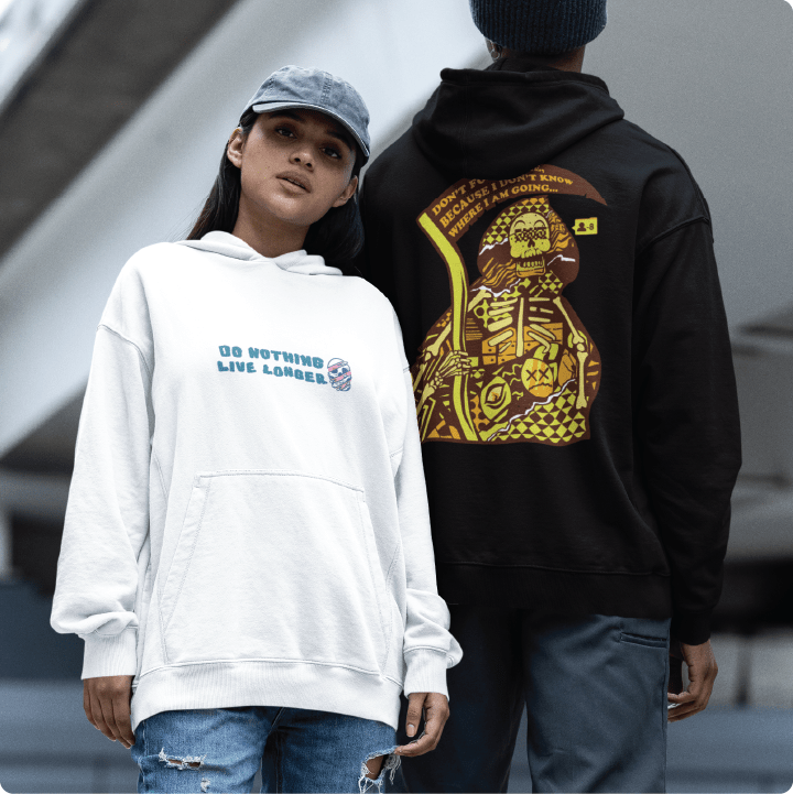 Two people wearing zdropped hoodies by fredy santiago, one white with 'Don Nothing Live Longer' text and the other black with a grim reaper skeleton design.