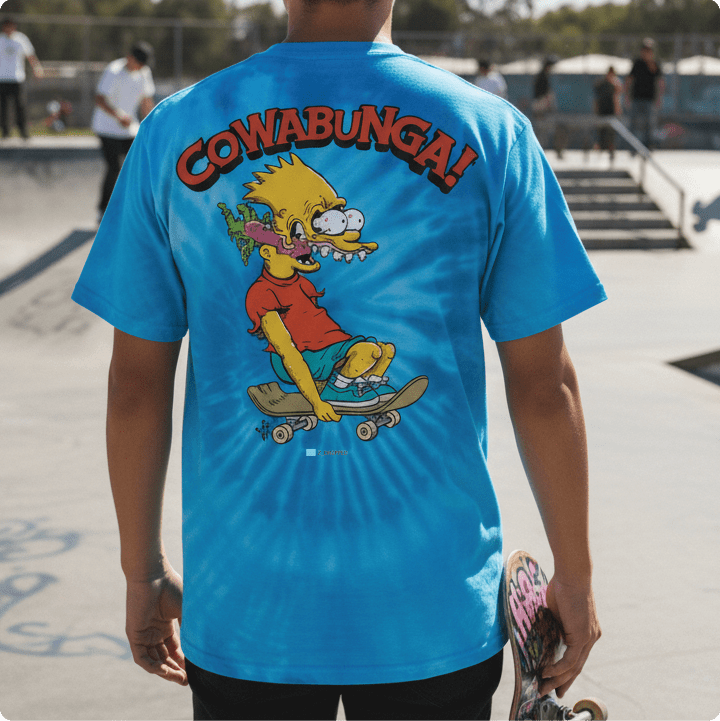 Rear view of a young man wearing a blue tie dye bart roth t-shirt at a skatepark.
