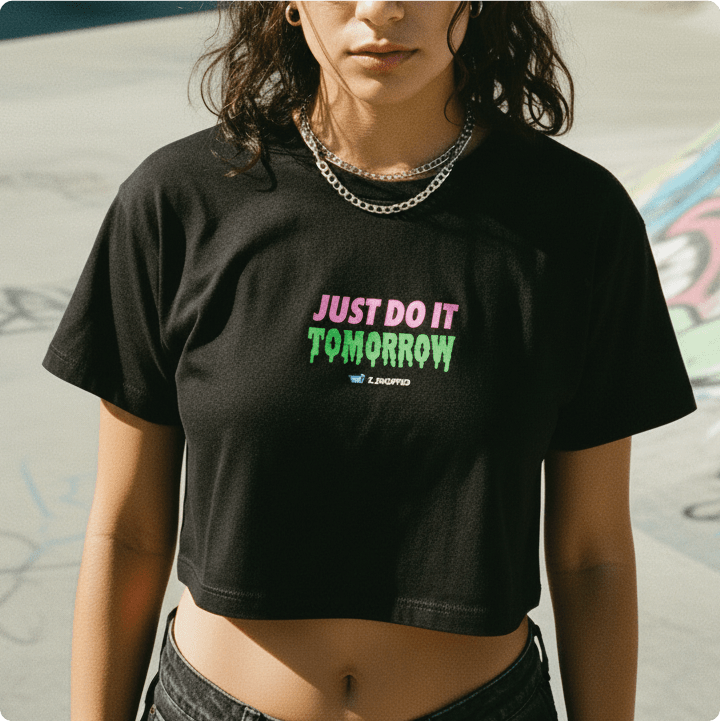 Young woman wearing a black t-shirt with 'JUST DO IT TOMORROW' text, standing in an outdoor setting.
