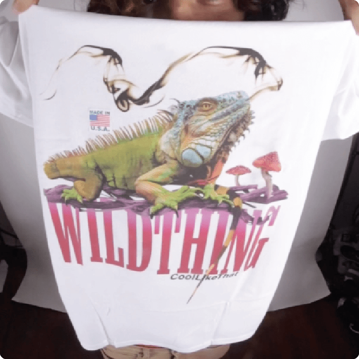 you crazy leo holding up the print quality of a white WILDTHING long sleeved t-shirt.