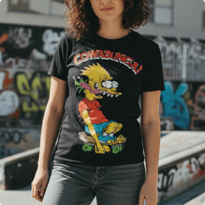 Person wearing a black t-shirt with a colorful graphic design in an urban setting