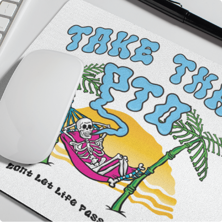 Mouse pad with skeleton in a hammock and text 'Take that PTO don't let life pass' on a desk.