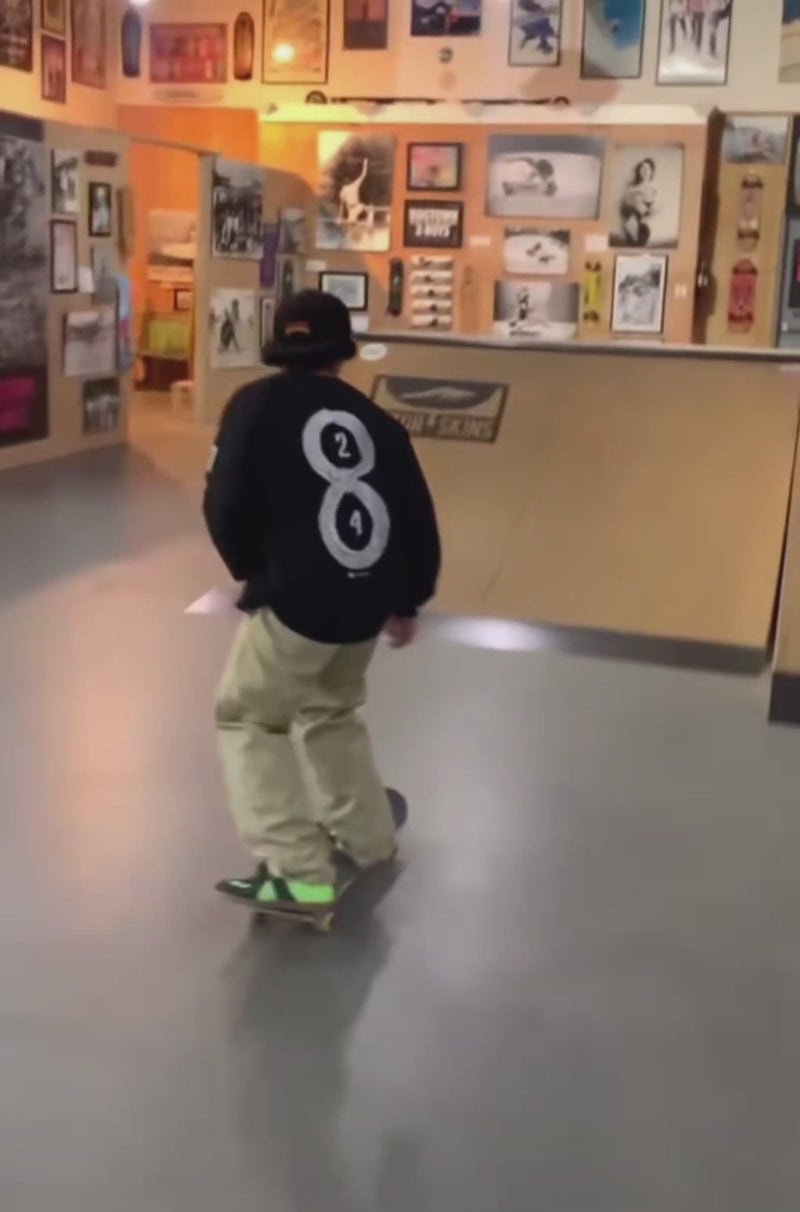 skater skating in a black mamba forever long sleeve shirt