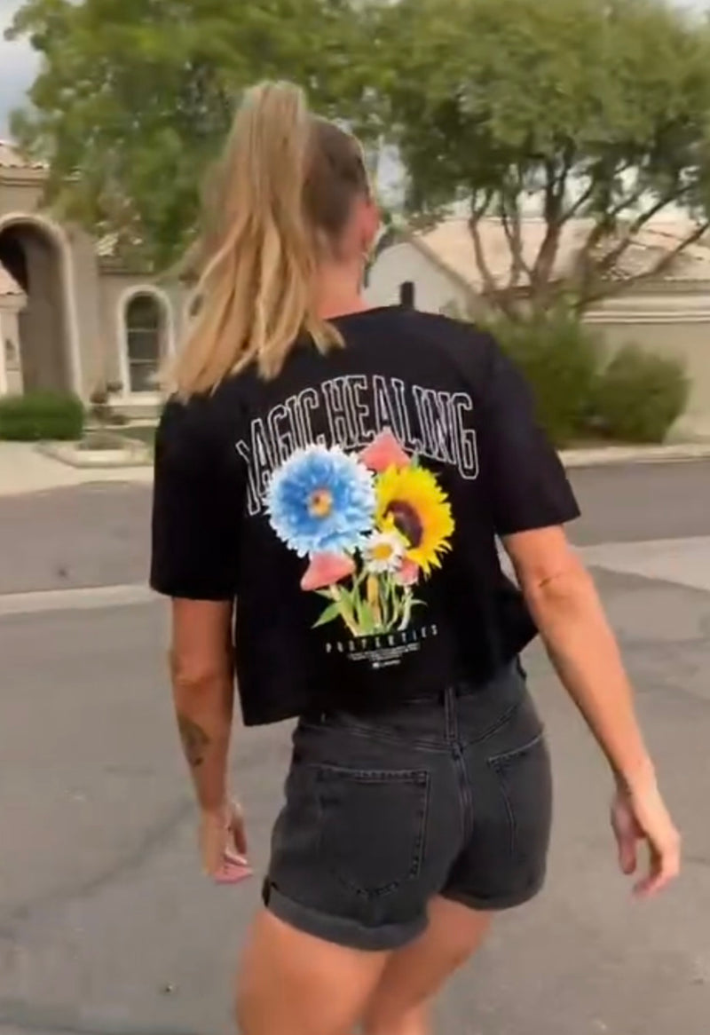 momskatestoo long boarding in a black magic healing crop top in her neighborhood street