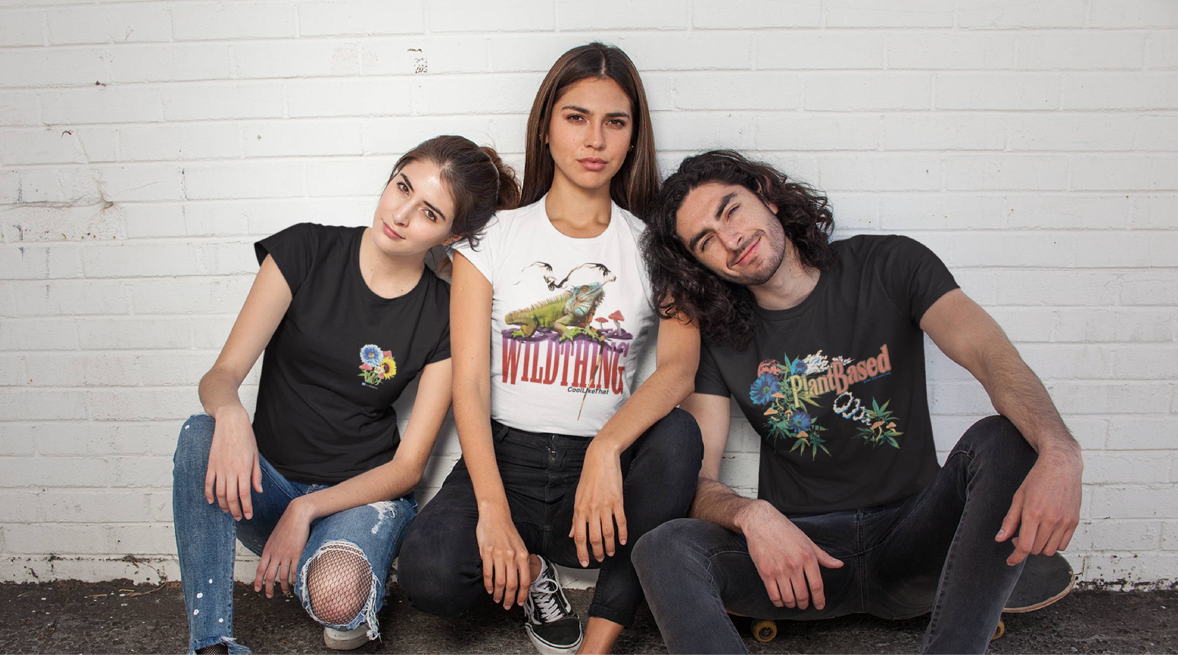 three friends wearing-zdropped chapter 3 t shirts crouching against a wall