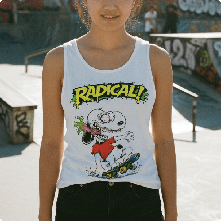 woman wearing a white tank top with a snoopy fink cartoon character and 'Radical!' text at a skate park.