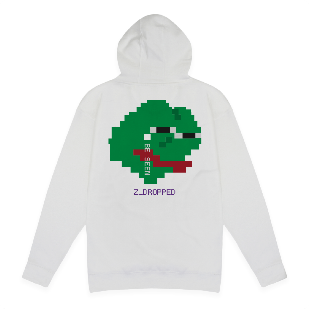 Rear view of a unisex white pullover hoodie with a large pixelated green sad frog face meme graphic featuring the words BE SEEN and Z DROPPED text, styled in retro 8-bit design, on a white background.