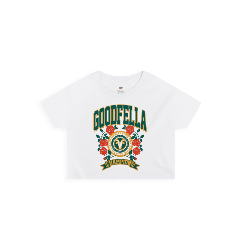 Front view of a women's white crop top shirt with a green and gold 'GOODFELLA CHAMPIONS' text roses and a G.O.A.T.
