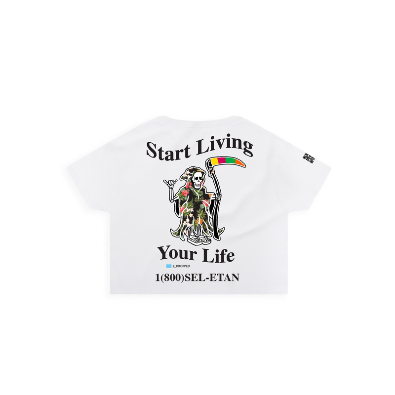 Rear view of a womens white crop top t-shirt with a graphic design featuring a skeleton holding a rainbow flag and text on a white background.
