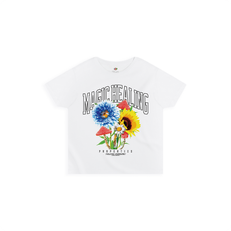 Front view of a women's white high waisted shirt with flowers psychedelic mushrooms and large black 'MAGIC HEALING' text.