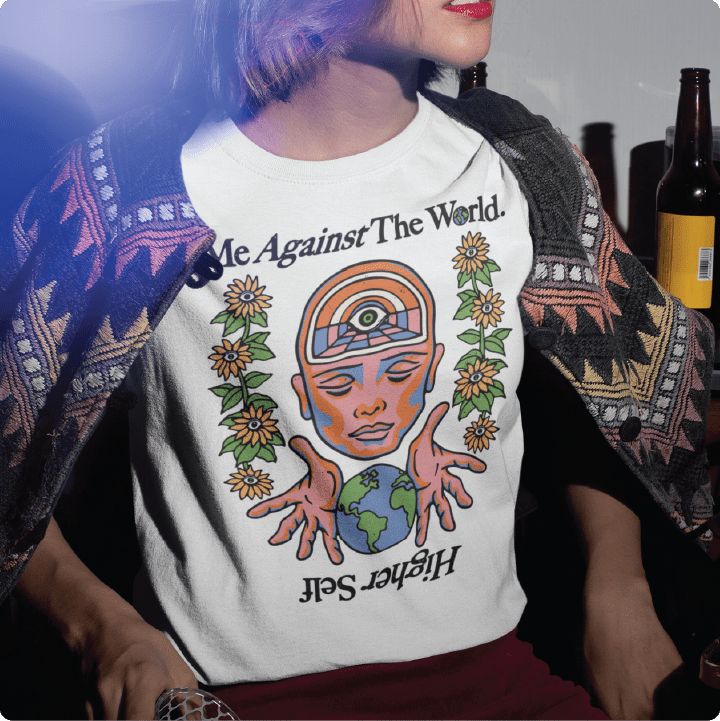 Person wearing a white high waist t-shirt with a Me Against The World design sitting at a house party.