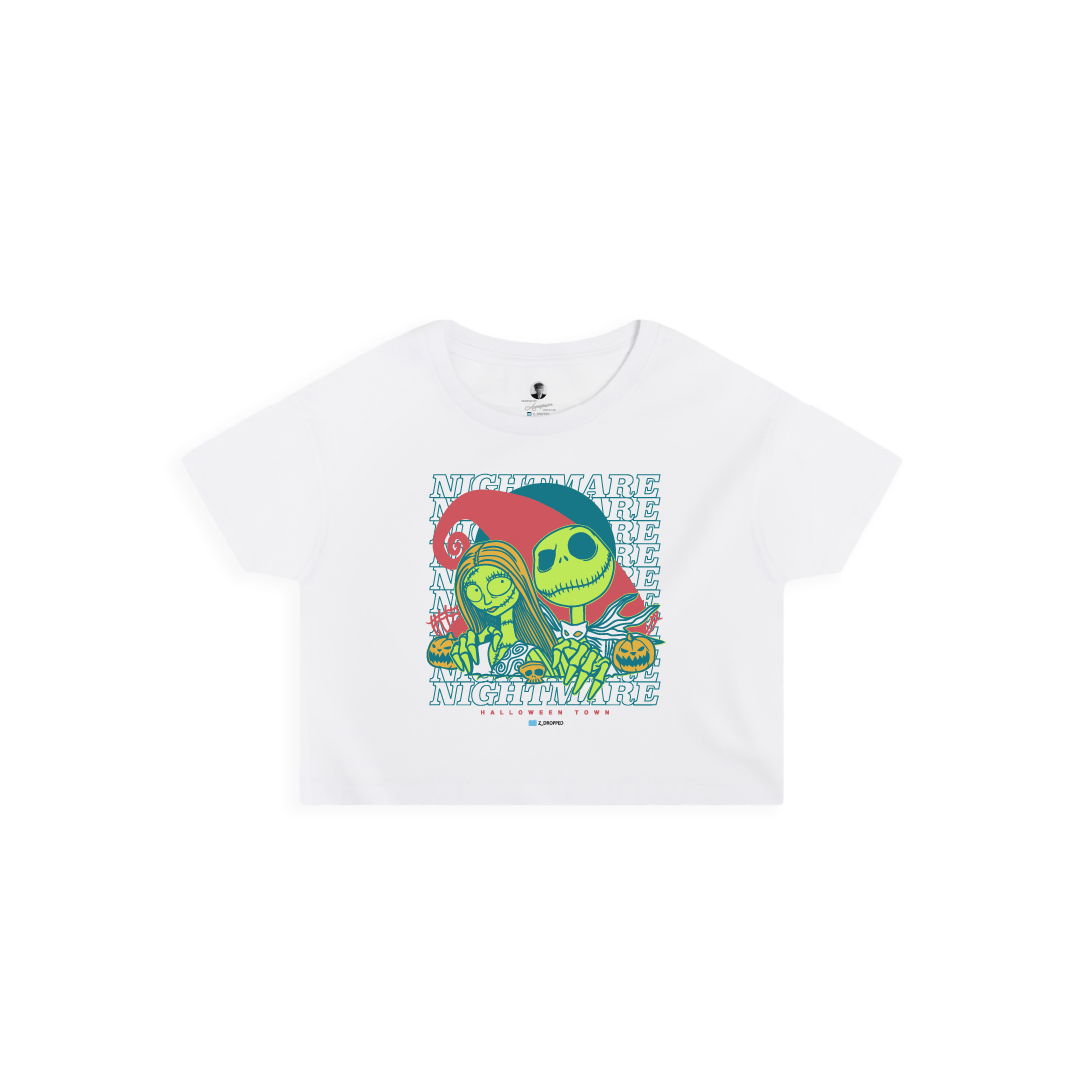 Front view of a womens white crop top with neon green cartoon skeletons and 'NIGHTMARE' text on a white background.